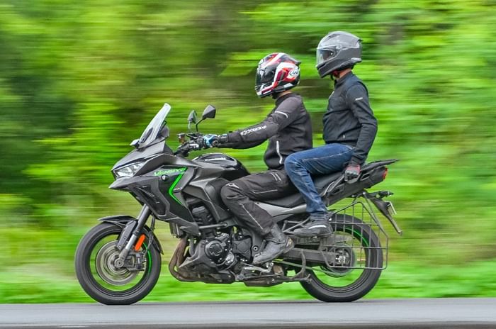 Kawasa Versys 1100 left side profile riding shot with rider and pillion
