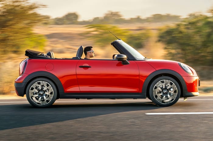Mini Convertible side profile driving on road